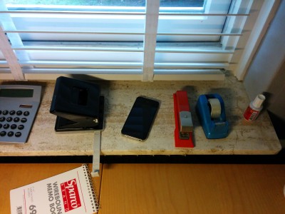 Out-of-order iPhone next to other commodity tools